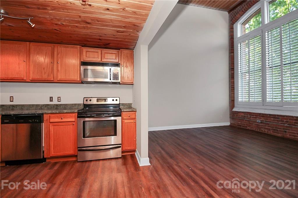 201 South Hoskins Road, Unit 237 Charlotte, NC 28208 - Photo 9 of 46 a kitchen with stainless steel appliances granite countertop a stove and cabinets