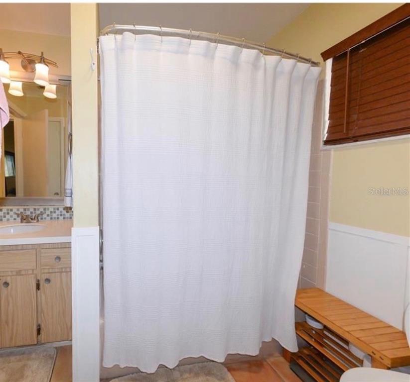 9215 Kingston Road Bradenton, FL 34210 - Photo 31 of 31 a bathroom with a shower curtain and a sink