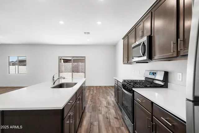 a kitchen with a refrigerator and a sink