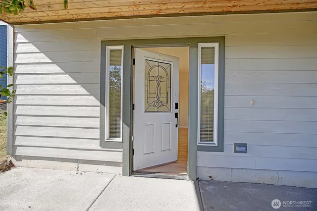 a view of a house with entryway and wooden door