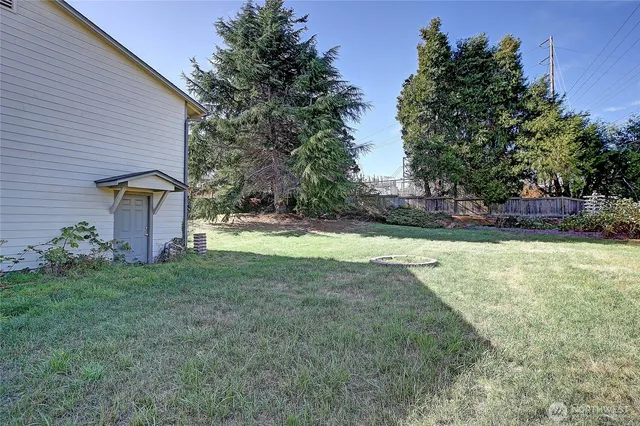 a view of a house with yard and tree s