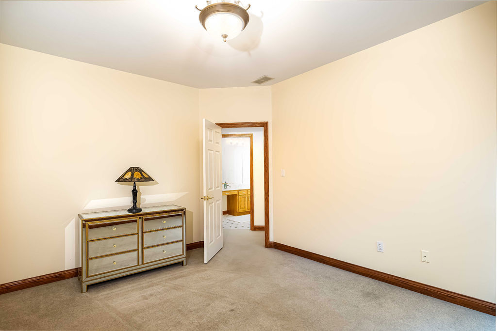 3208 Buried Oak Drive Crete, IL 60417 - Photo 18 of 26 a room with a bed and a chandelier