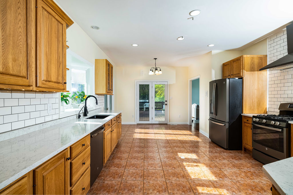 3208 Buried Oak Drive Crete, IL 60417 - Photo 6 of 26 a large kitchen with stainless steel appliances granite countertop a sink and a refrigerator