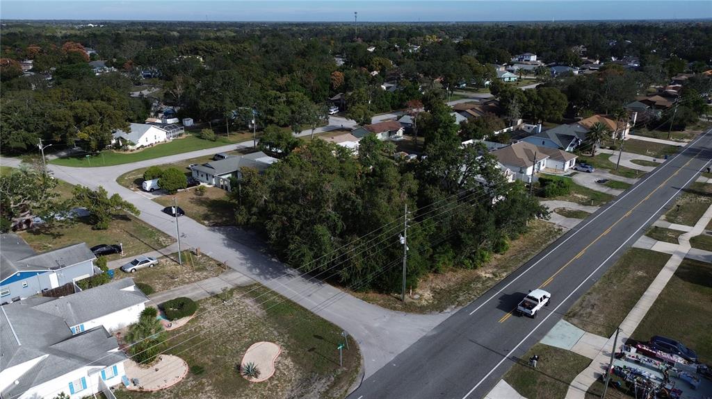 3263 Deltona Boulevard Spring Hill, FL 34606 - Photo 14 of 18 an aerial view of multiple houses with yard