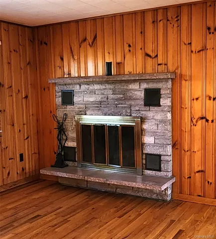 an open room with wooden floor and windows