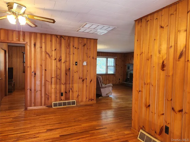 a view of a room with wooden floor and chair