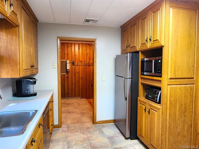 a kitchen with stainless steel appliances granite countertop a refrigerator and a stove