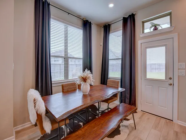 a view of a dining room with furniture window and wooden floor