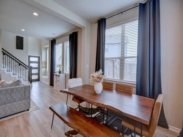 a view of a dining room with furniture and wooden floor
