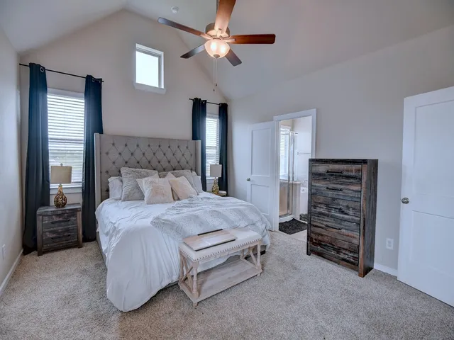 a bedroom with a bed and a ceiling fan