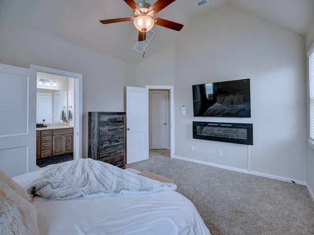 a bedroom with a bed and a television