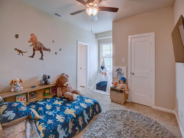 a bedroom with bed and wooden floor