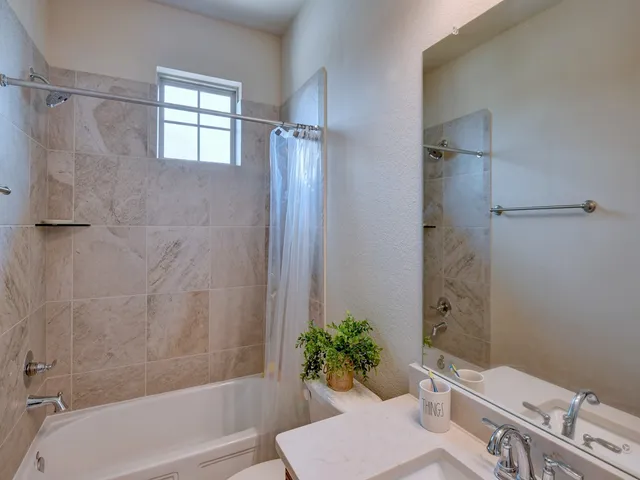 a bathroom with a shower curtain and a bathtub