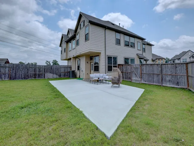 a view of a house with a swimming pool and a yard