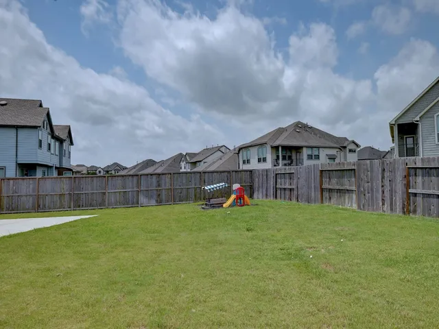 a view of a house with a yard and sitting area
