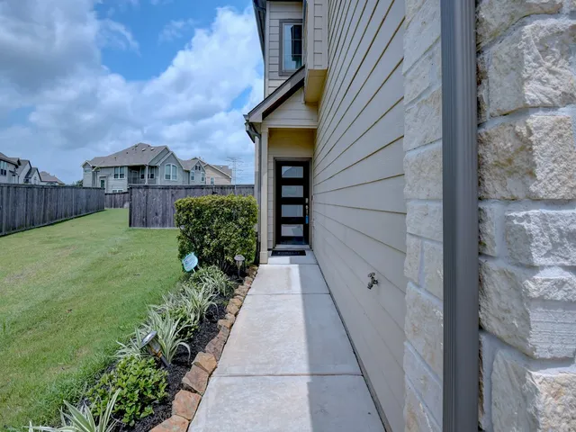 a view of a pathway both side of house