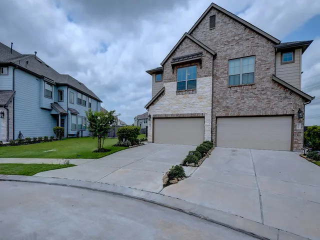 front view of house with a yard and a garage
