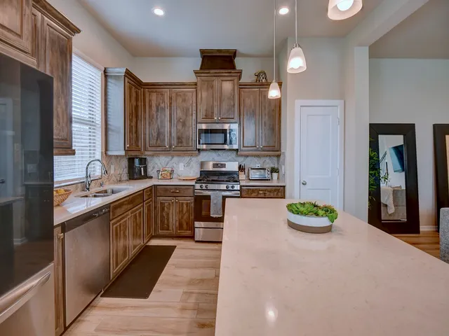 a kitchen with a sink cabinets and stainless steel appliances
