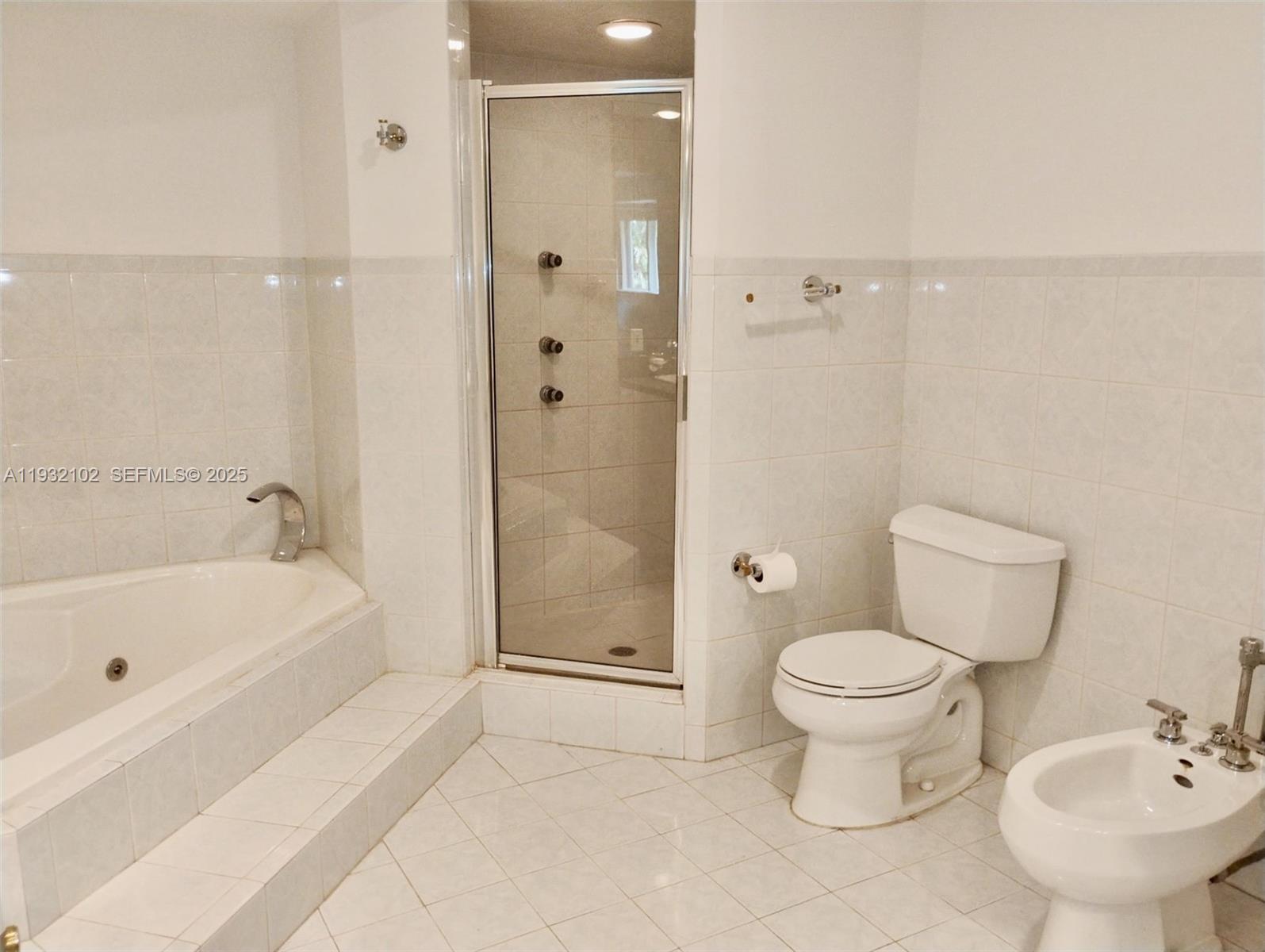 16021 Southwest 173rd Avenue Miami, FL 33187 - Photo 18 of 30 a bathroom with a sink toilet a shower and bathtub