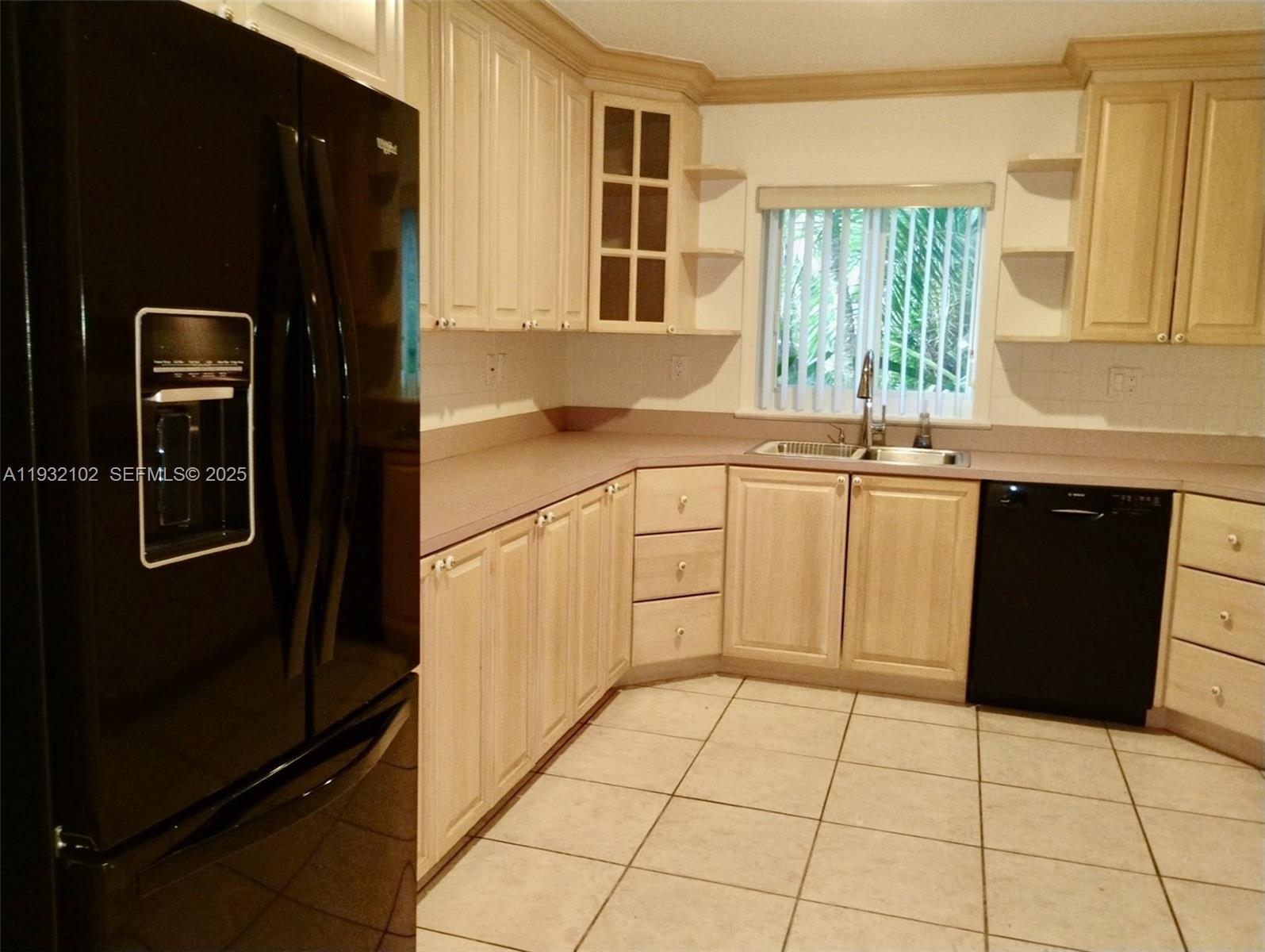 16021 Southwest 173rd Avenue Miami, FL 33187 - Photo 30 of 30 a kitchen with a refrigerator sink and cabinets