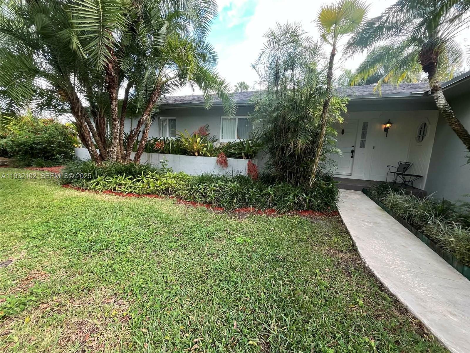 16021 Southwest 173rd Avenue Miami, FL 33187 - Photo 6 of 30 a view of a house with a yard