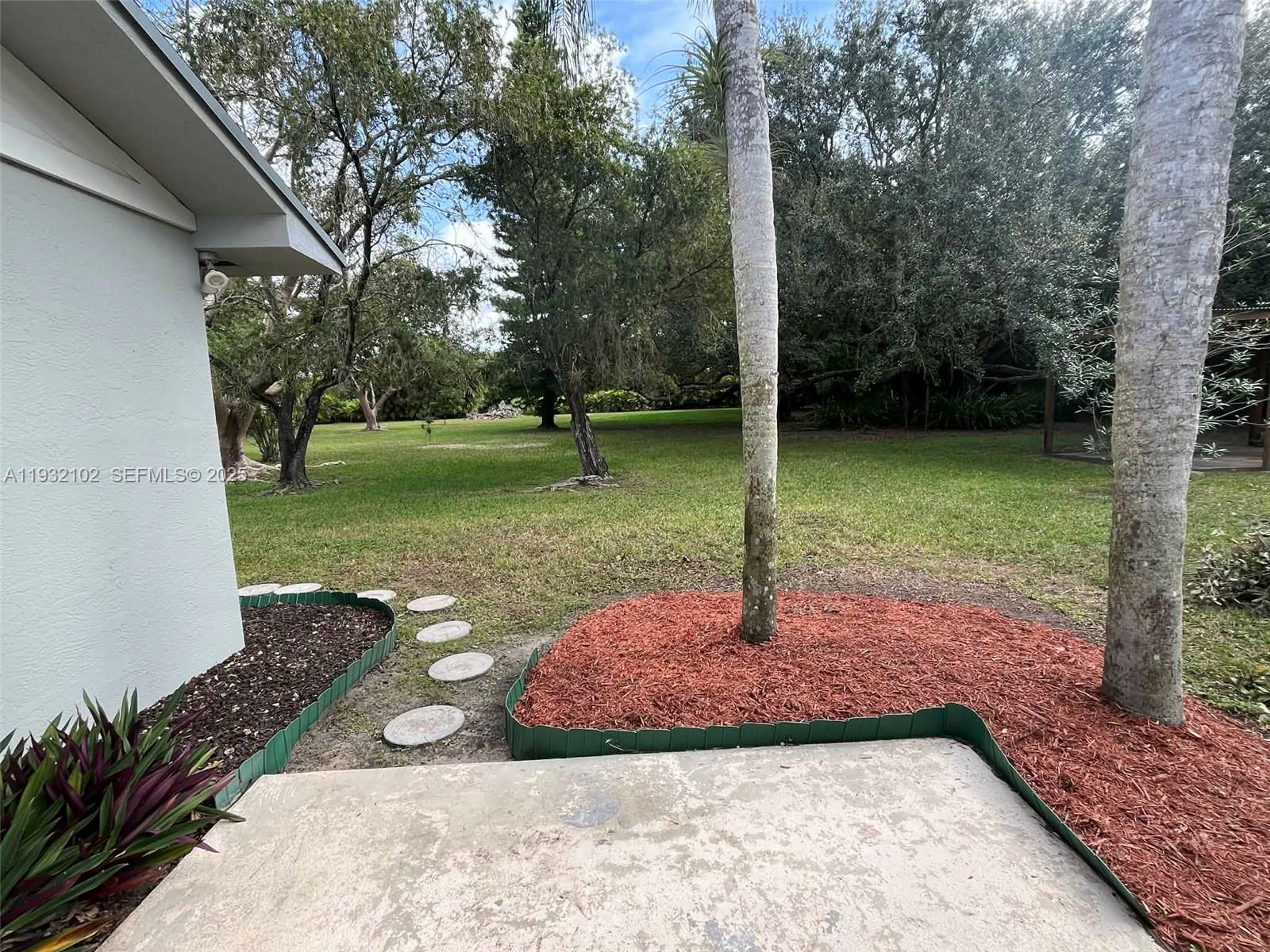 16021 Southwest 173rd Avenue Miami, FL 33187 - Photo 8 of 30 a view of a backyard with green space