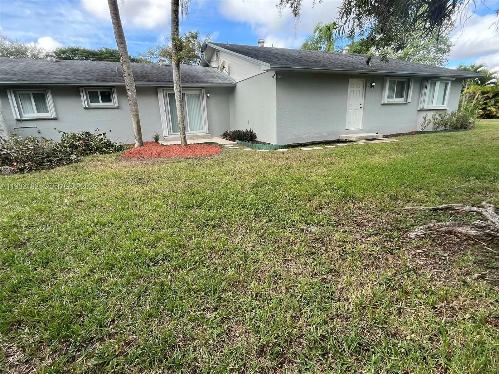 16021 Southwest 173rd Avenue Miami, FL 33187 - Photo 9 of 30 a front view of a house with a yard