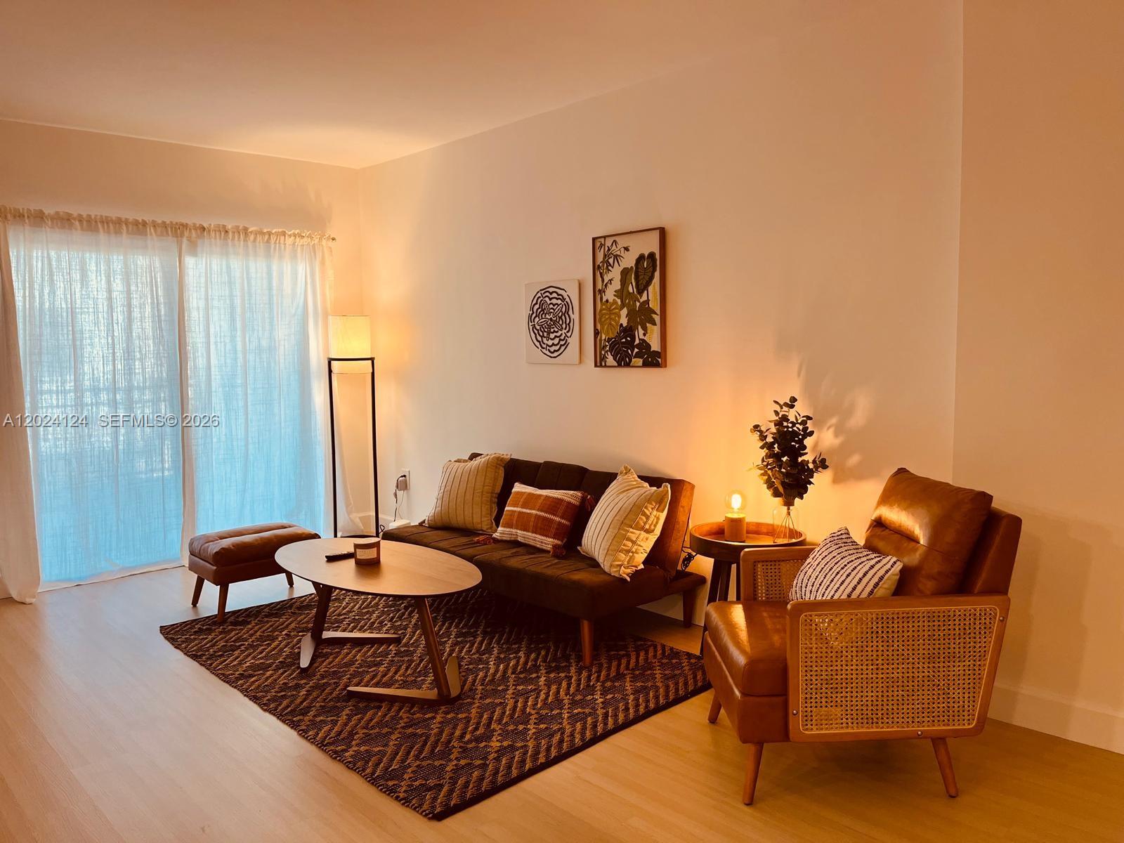 120 South Douglas Road, Unit 302 Miami, FL 33134 - Photo 2 of 28 a living room with furniture and wooden floor
