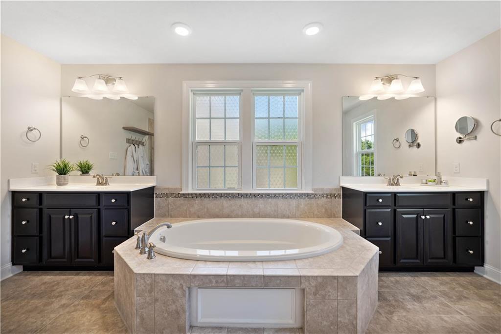 4449 Walnut Ridge Circle McDonald, PA 15057 - Photo 20 of 40 a bathroom with a tub sink and mirror