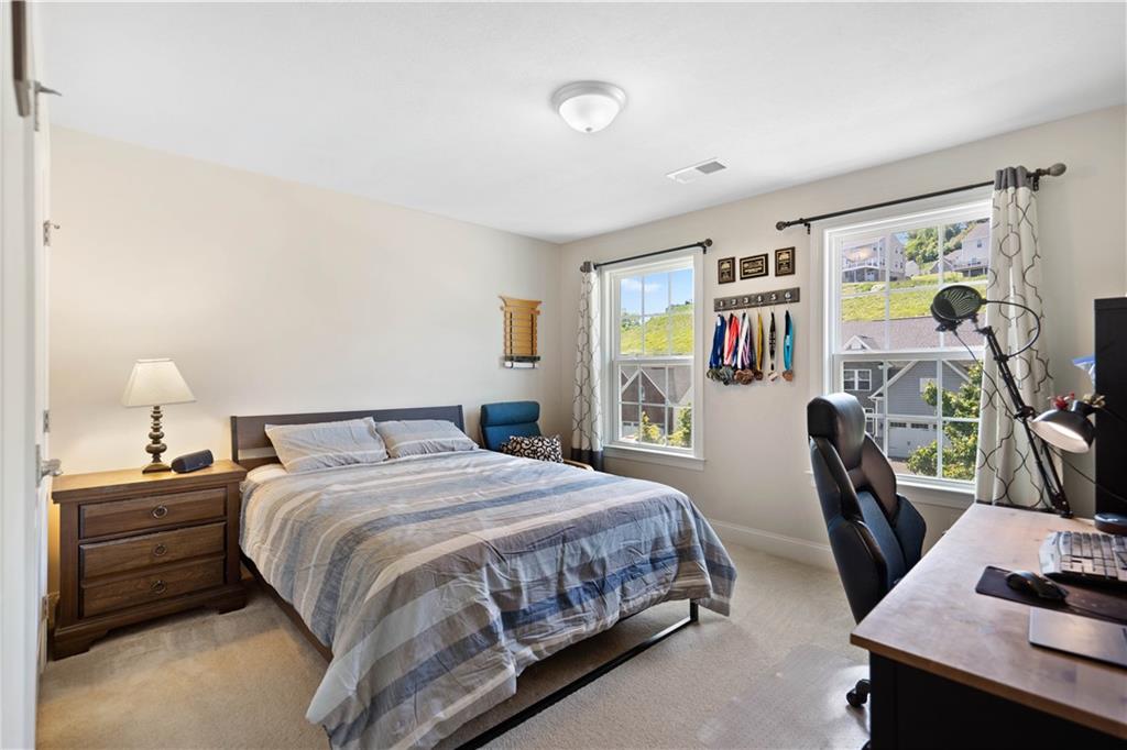 4449 Walnut Ridge Circle McDonald, PA 15057 - Photo 21 of 40 a bedroom with a bed a desk and chair with the wooden floor