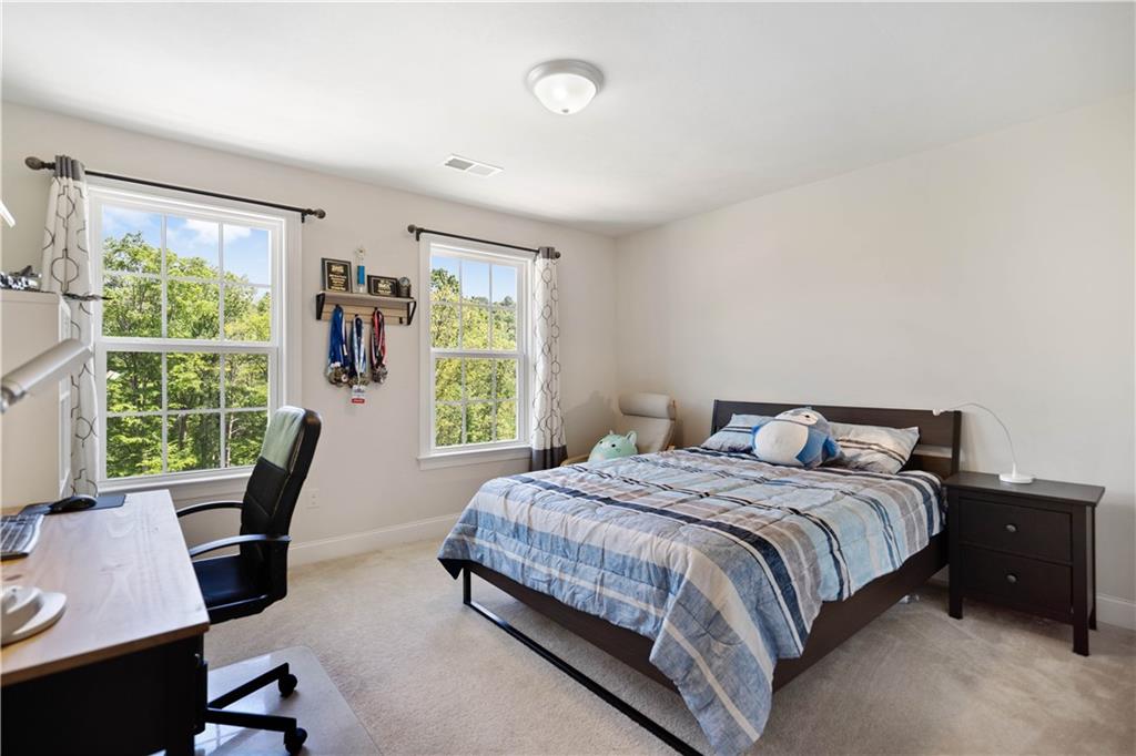 4449 Walnut Ridge Circle McDonald, PA 15057 - Photo 22 of 40 a bedroom with a bed a desk and chair with a large window