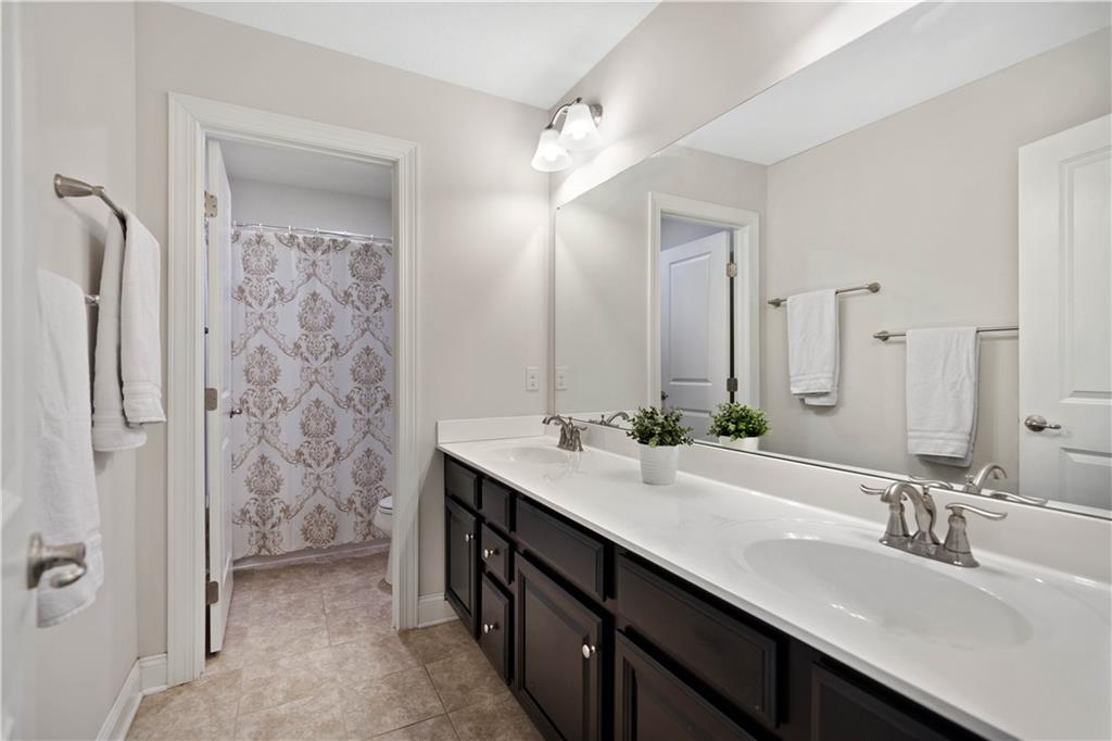 4449 Walnut Ridge Circle McDonald, PA 15057 - Photo 23 of 40 a bathroom with a double vanity sink a mirror and a shower