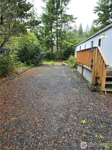 a view of a house with backyard and trees