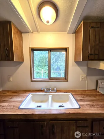 a view of a kitchen with a sink and window