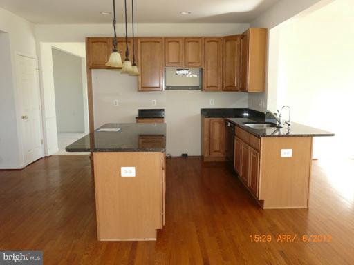 78 Glenbrook Road Ranson, WV 25438 - Photo 11 of 17 a kitchen with stainless steel appliances granite countertop a stove a sink and a refrigerator