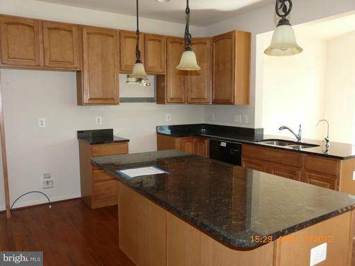 78 Glenbrook Road Ranson, WV 25438 - Photo 15 of 17 a kitchen with stainless steel appliances granite countertop a sink a microwave and wooden cabinets
