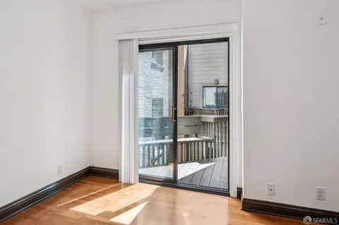 a view of a balcony with wooden floor
