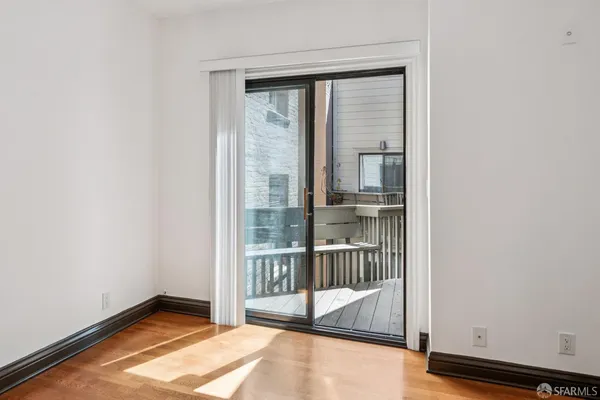 a view of a balcony with wooden floor