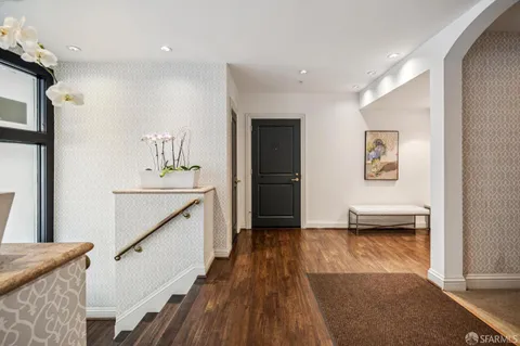 a view of hallway with wooden floor and stairs
