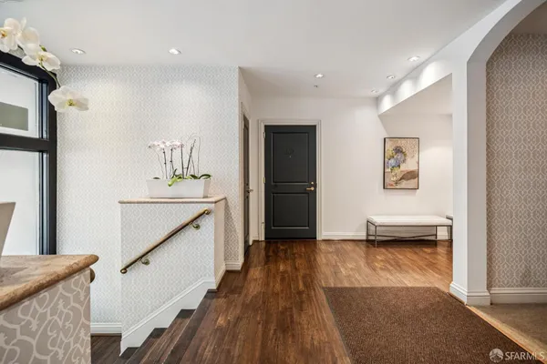 a view of hallway with wooden floor and stairs