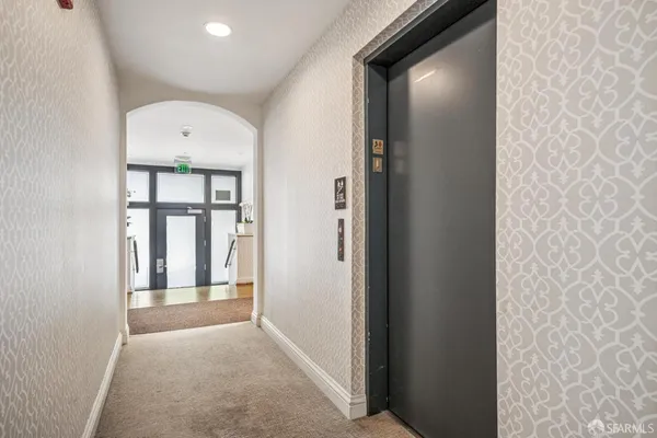 a view of a hallway with windows and entryway