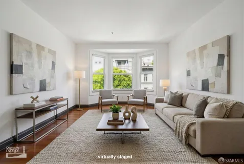 a living room with furniture wooden floor and a large window