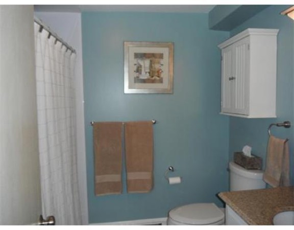 5 Hallmark Gardens, Unit 1 Burlington, MA 01803 - Photo 11 of 15 a bathroom with a toilet and a shower curtain