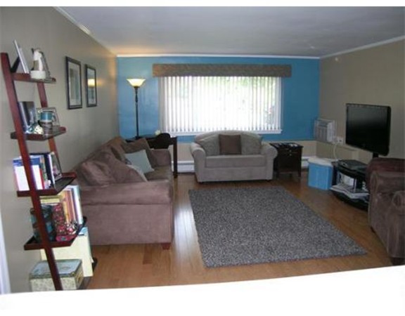 5 Hallmark Gardens, Unit 1 Burlington, MA 01803 - Photo 4 of 15 a living room with furniture and a flat screen tv
