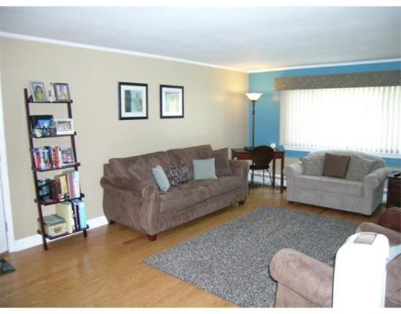 5 Hallmark Gardens, Unit 1 Burlington, MA 01803 - Photo 5 of 15 a living room with furniture and a large window