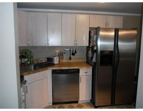 5 Hallmark Gardens, Unit 1 Burlington, MA 01803 - Photo 6 of 15 a kitchen with a refrigerator and cabinets