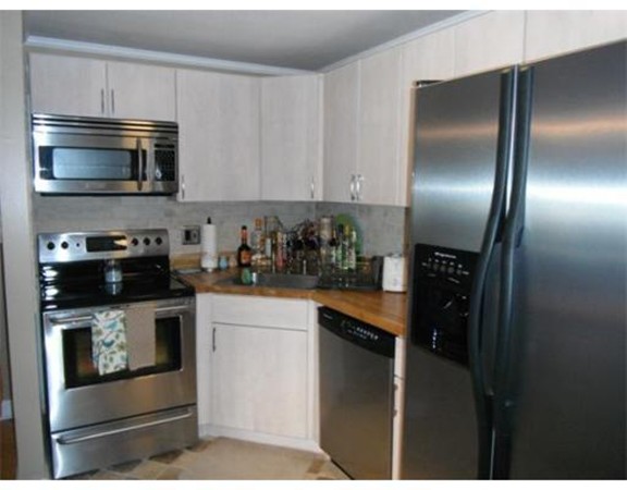 5 Hallmark Gardens, Unit 1 Burlington, MA 01803 - Photo 8 of 15 a kitchen with stainless steel appliances granite countertop a refrigerator a stove a microwave and sink
