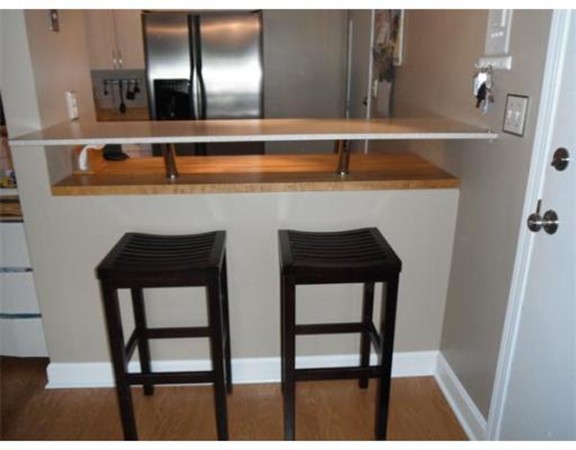 5 Hallmark Gardens, Unit 1 Burlington, MA 01803 - Photo 9 of 15 a dining room with table chairs and wooden floor