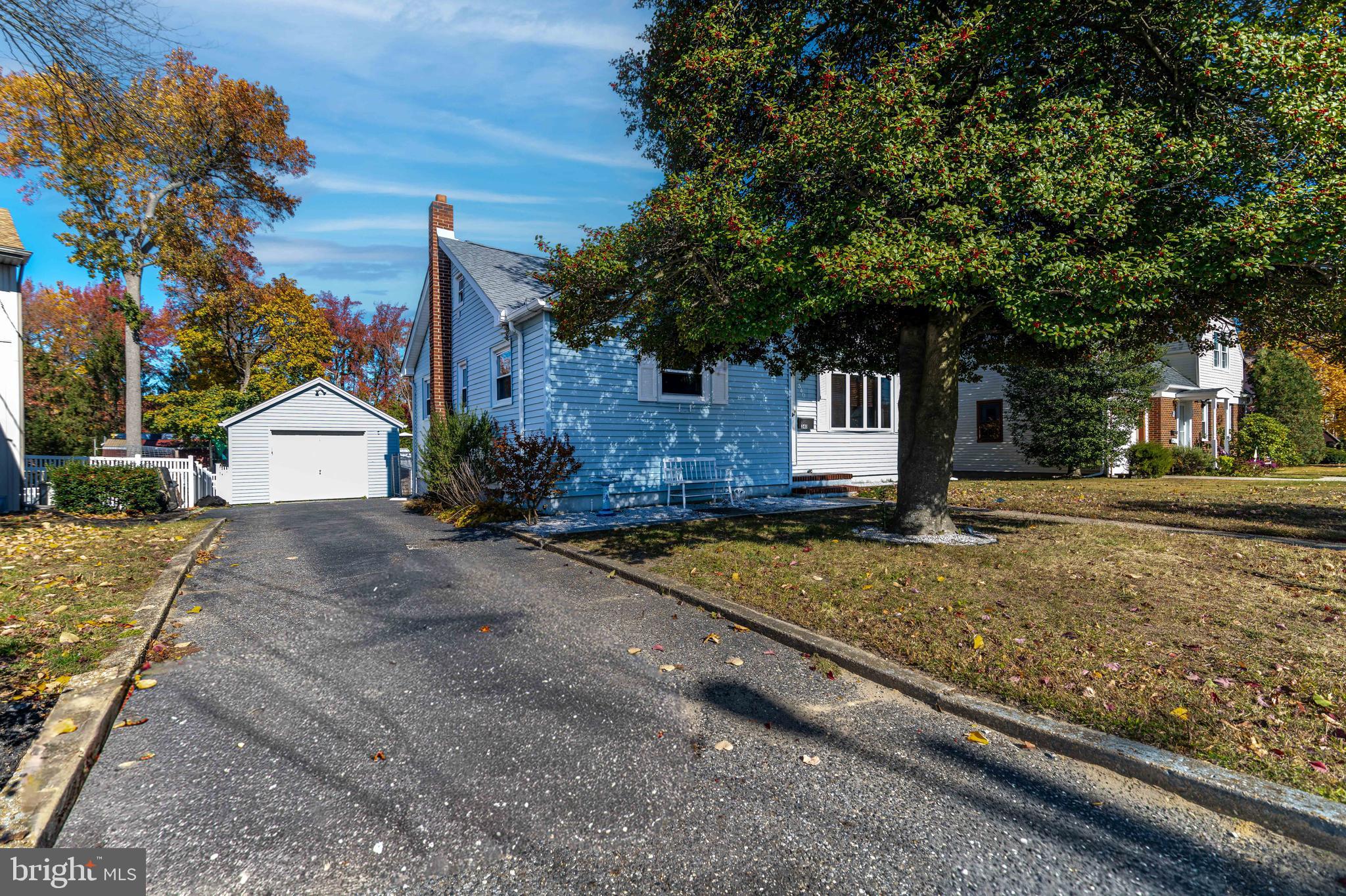 340 High Street Woodbury, NJ 08096 - Photo 13 of 14 a view of a white house with a yard and large tree