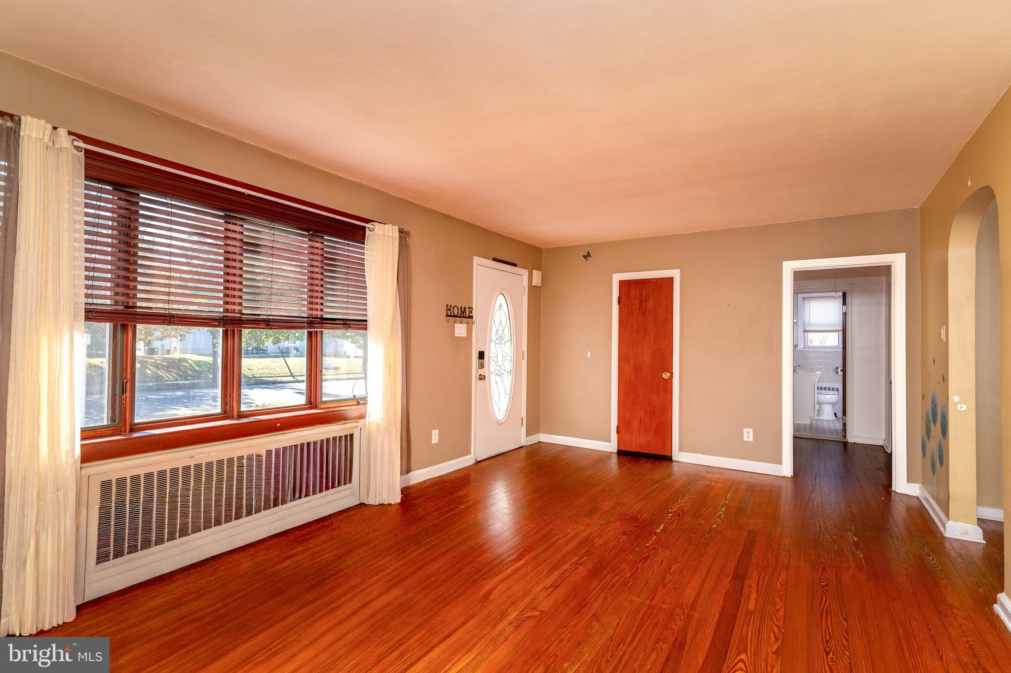 340 High Street Woodbury, NJ 08096 - Photo 4 of 14 a view of a room with wooden floor and windows